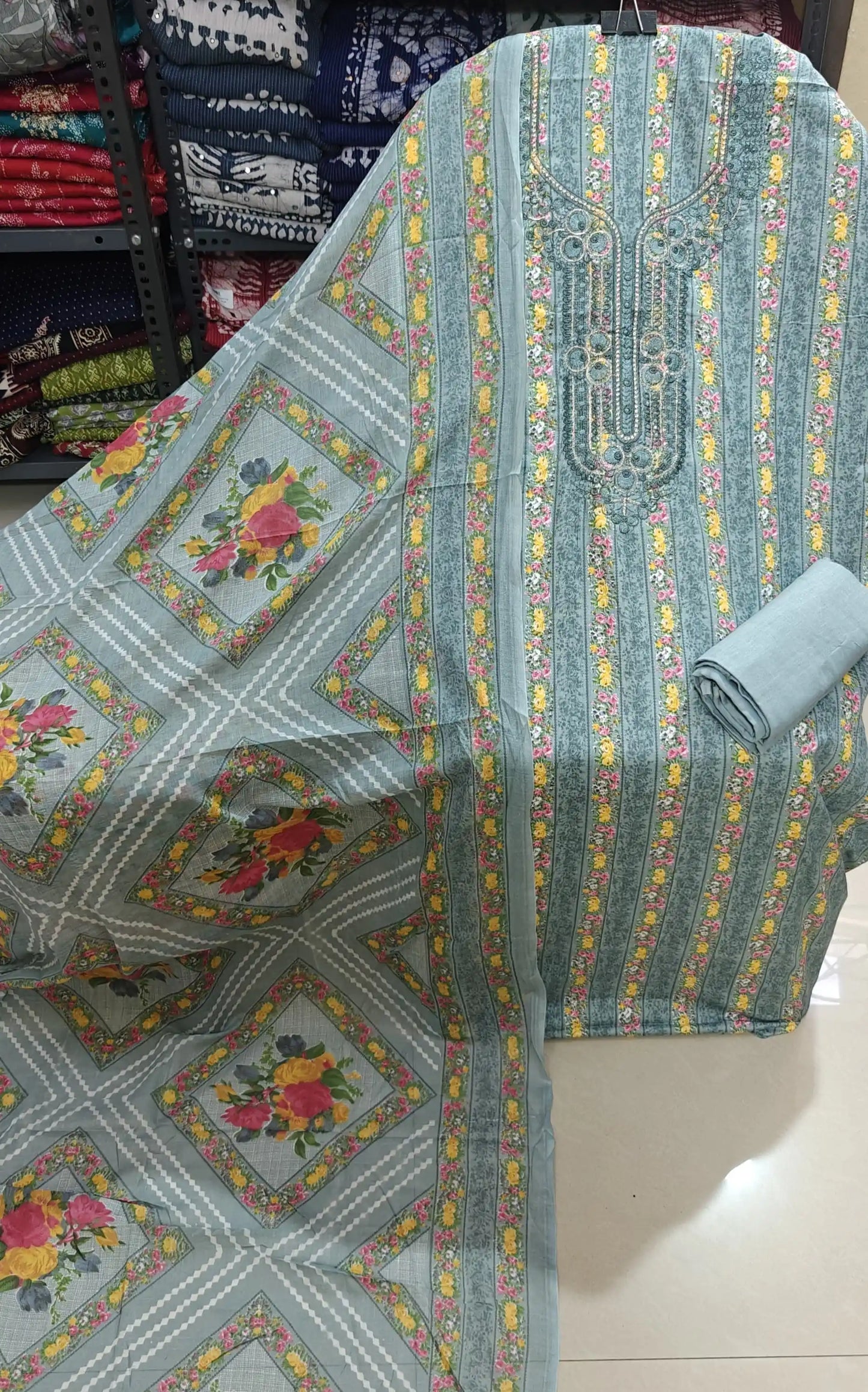 Premium grey cotton unstitched suit with floral print stripes and embroidered neckline.