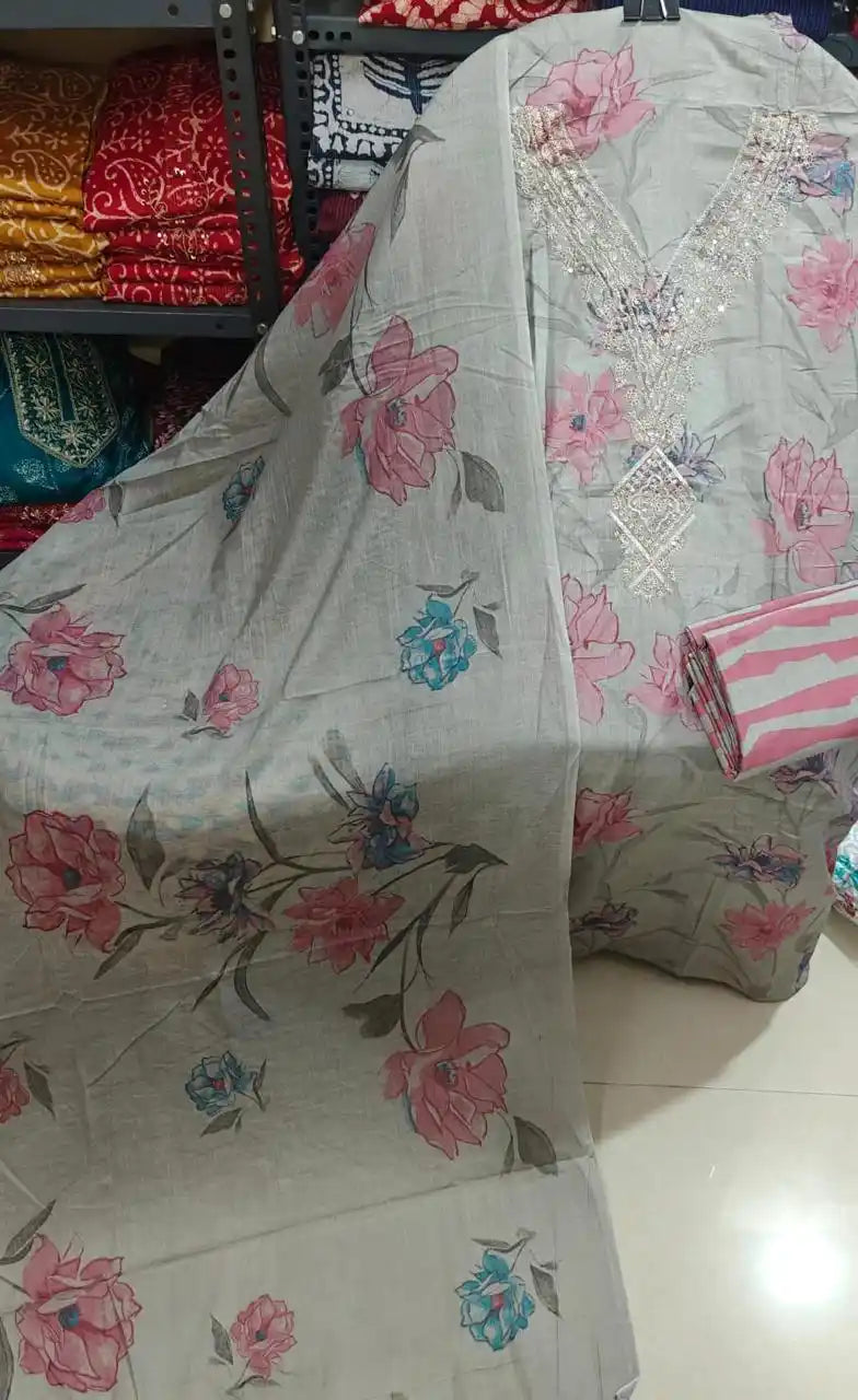 Grey soft cotton salwar suit featuring pink floral motifs and intricate silver embroidery on the neck.