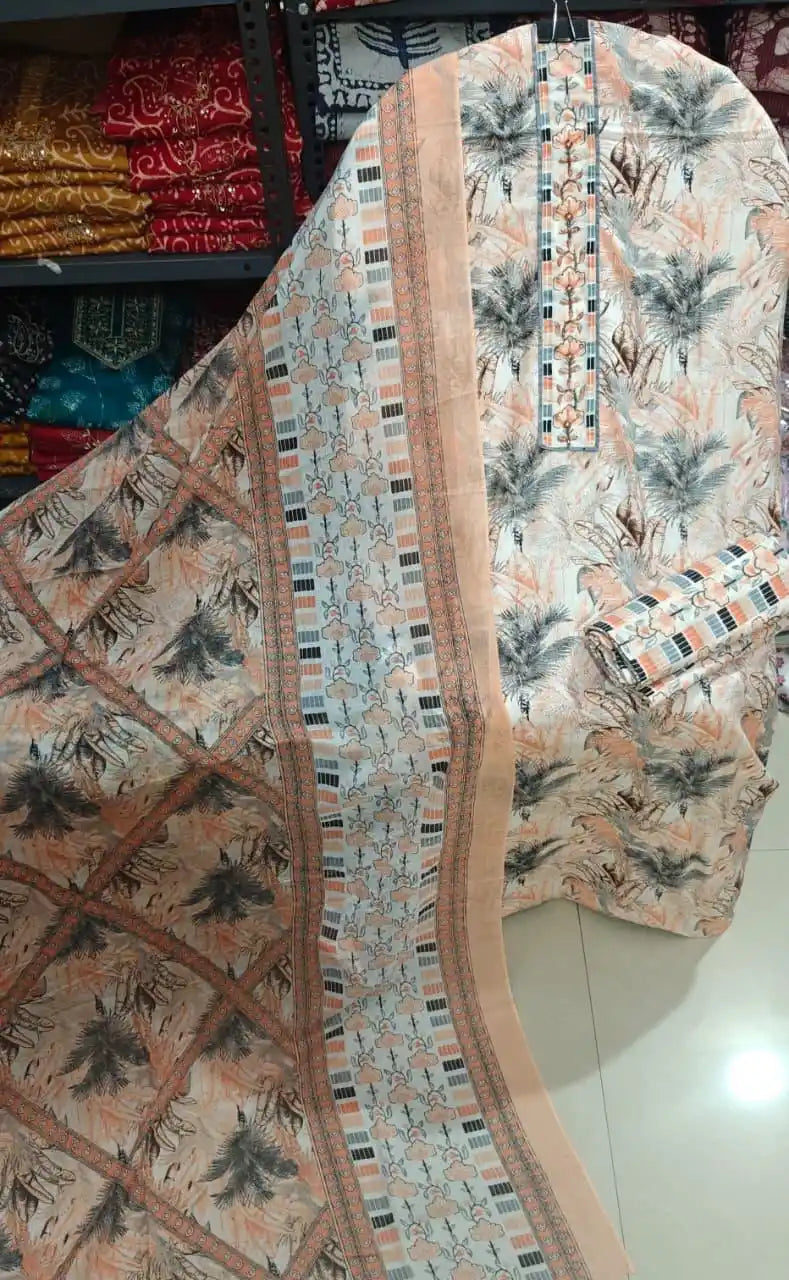 Peach and white cotton suit with dark palm leaf prints and a patterned geometric dupatta border.