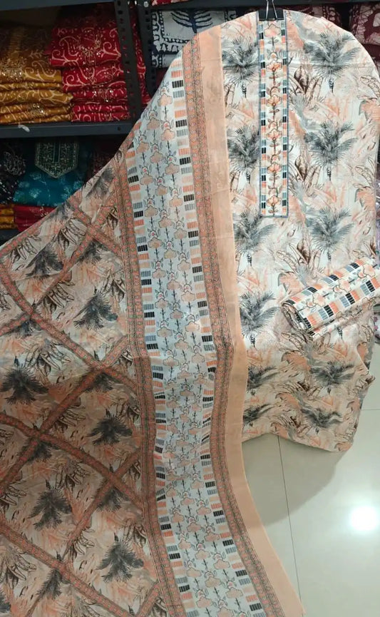 Peach and white cotton suit with dark palm leaf prints and a patterned geometric dupatta border.