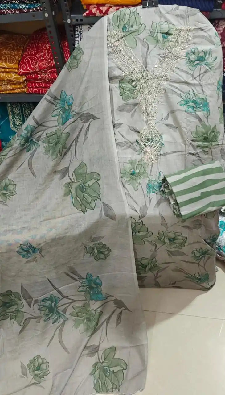 Grey base cotton suit fabric decorated with big green flowers and an elegant embroidered neck patch.