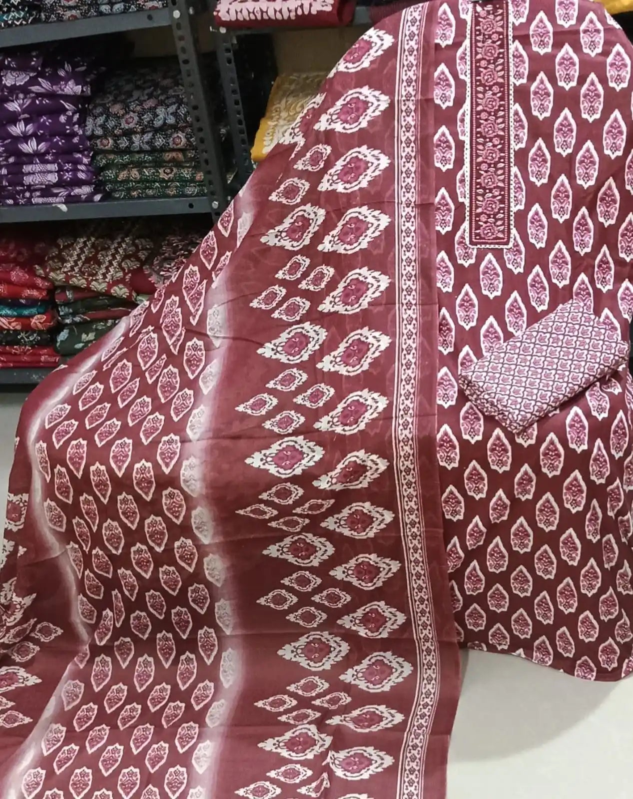 Deep wine cotton suit featuring a contrasting cream embroidered center neck panel, ethnic ikat patterns, and a double-shaded printed dupatta.