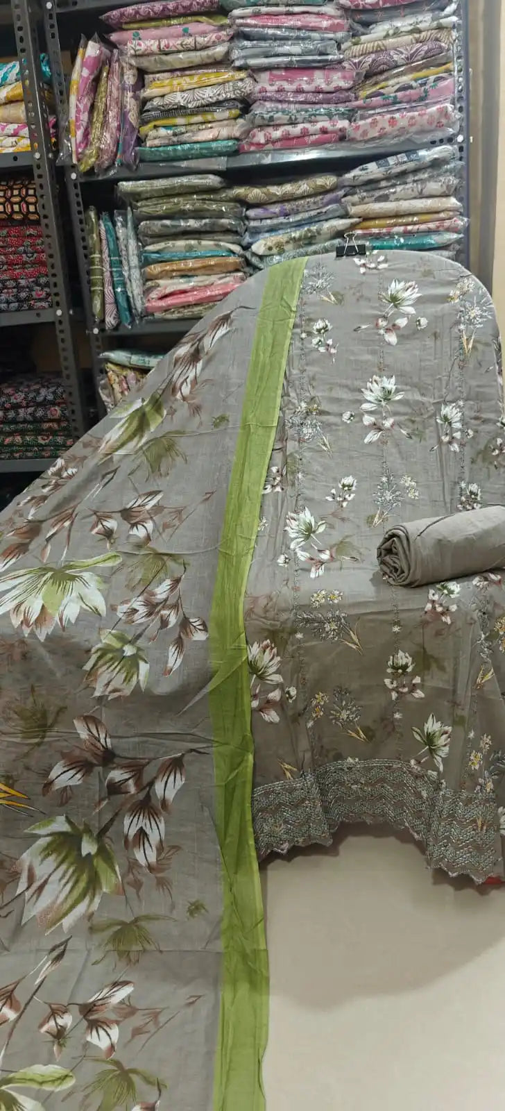 Earthy taupe gray unstitched cotton fabric with elegant white and green floral prints, featuring a matching gray bottom roll and a matching dupatta finished with a lime green contrast border.