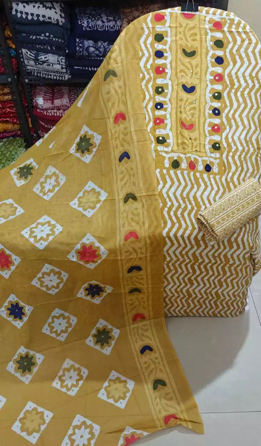 Mustard chevron print unstitched suit with mirror work displayed on a hanger.
