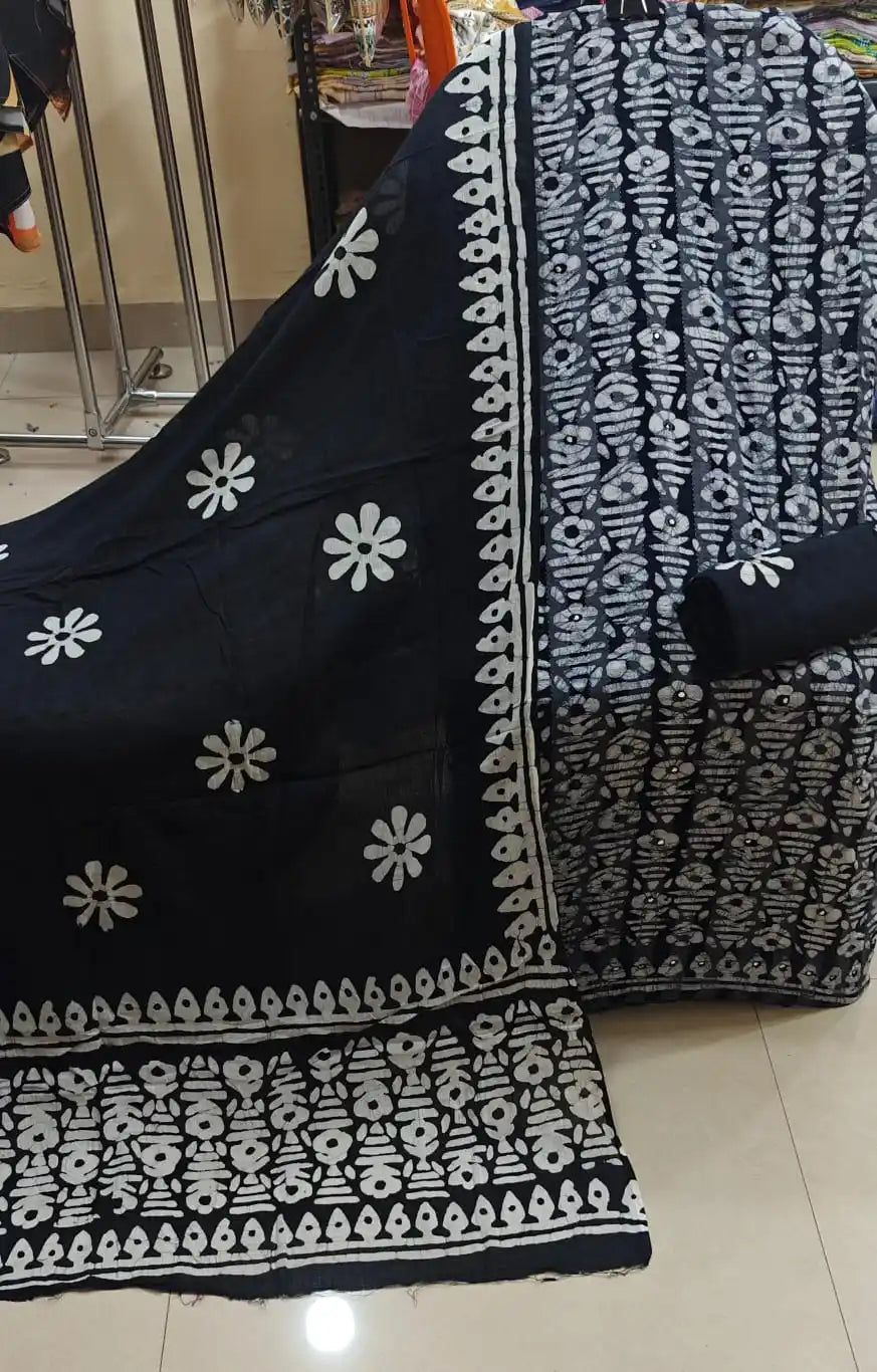 Black and white unstitched pure cotton fabric set featuring geometric block prints with a matching black dupatta displaying large white floral motifs and ethnic borders by ASC.