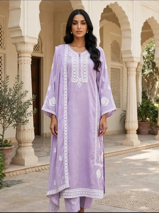 Lavender Purple Embroidered Designer Suit by  featuring a premium cotton jacquard kurta with white floral embroidery, 52-inch top, matching 39-inch straight pants, and a 2.25-metre lavender dupatta with white embroidered border.