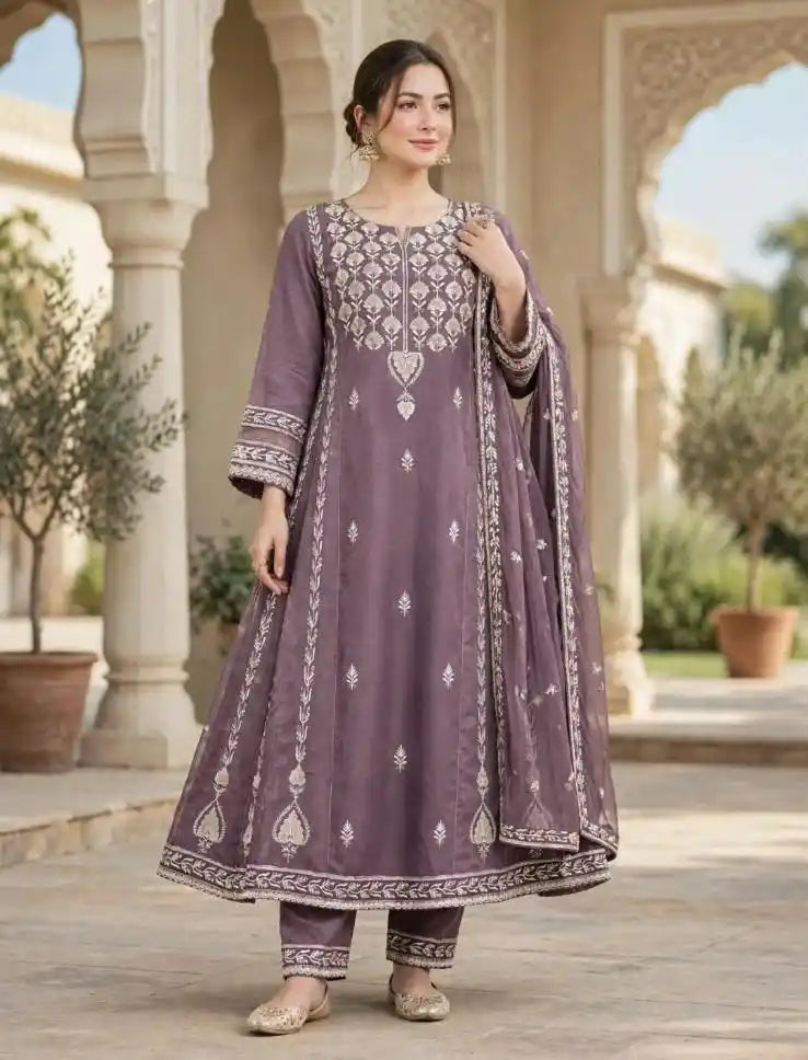 Woman wearing mauve purple flared Anarkali suit with ivory embroidery, matching pants and dupatta