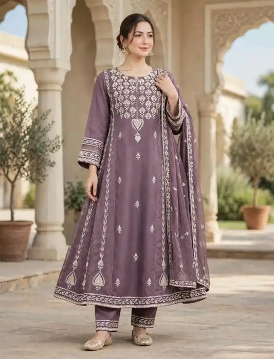 Woman wearing mauve purple flared Anarkali suit with ivory embroidery, matching pants and dupatta
